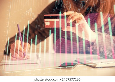 Double exposure of woman on-line shopping holding a credit card and financial graph drawing. Stock market E-commerce concept. - Powered by Shutterstock