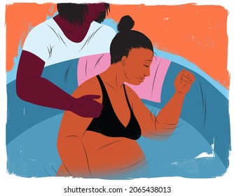 Doula comforting a pregnant woman in a birthing pool during labor