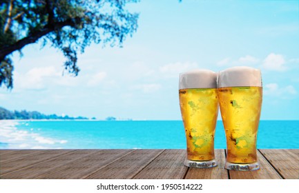 Draft or craft beer in a tall clear glass With beer foam on top And there are bubbles in the glass. Cold beer in a glass, placed on a wooden table on the beach, the sea during the day. 3D Rendering - Powered by Shutterstock