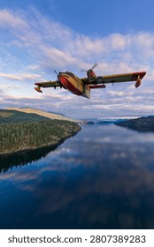 Dramatic 3D rendering of a yellow-red water bomber seaplane flying low over a coastal lake with forested islands, background from BC Canada, aerial firefighting concept and rescue imagery.