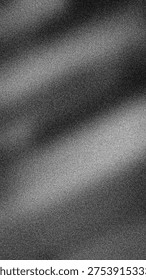 Dramatic abstract grainy monochrome gradient of black, white, and gray. High-contrast 4K backdrop template with cinematic spotlight effect