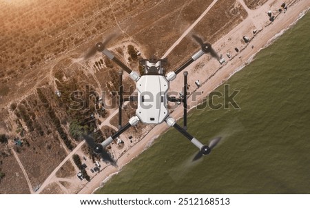 Drone (quadcopter) observer with action camera. Coastal zone control. Flying over the sea and the beach. Background: photo. Drone: 3d model. 3d illustration.