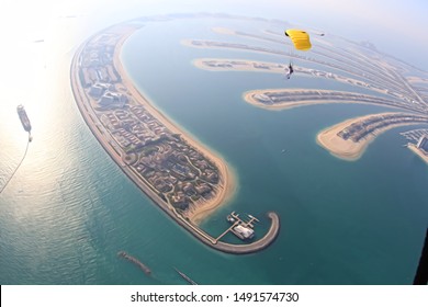 Dubai 2020. Skydiving Men Rest On Dubai Palm In Free Fall. Skydive Dubai. 