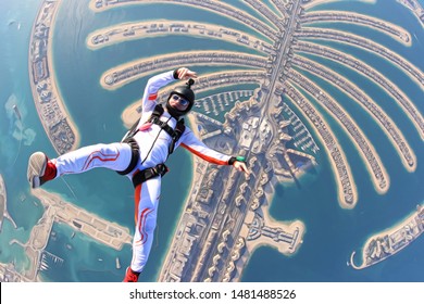 Dubai UAE Trip. Skydiving Men Rest On Dubai Palm In Free Fall. Skydive Dubai Trip. Arab Emirates Fly.