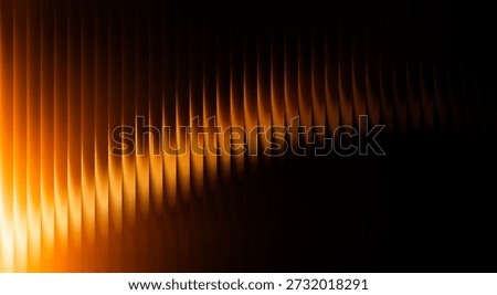 Dynamic abstract image featuring glowing orange waves against a dark background, creating a sense of motion and energy with a modern aesthetic.