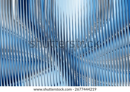 Dynamic blue abstract background with wavy vertical ribbed texture and shimmering light effects, suggesting movement and fluidity