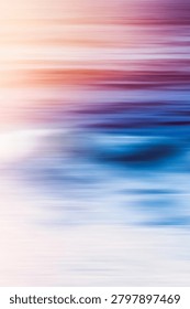 Dynamic fluid motion blur creating an abstract composition with vibrant sunset colors blending into blue ocean waves and white beach sand