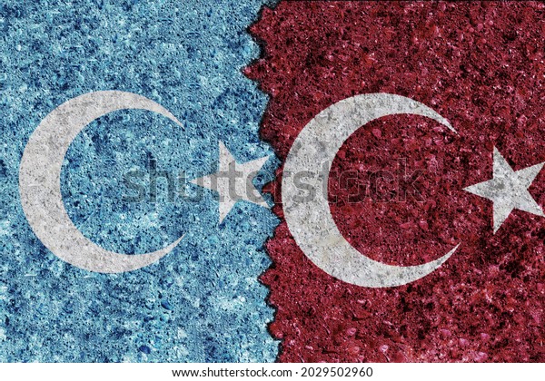 East Turkestan and Turkey flags painted on grunge\
texture wall. Flag of\
uyghurs