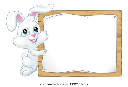 The Easter Bunny Rabbit peeking around a sign background and pointing at it. - Powered by Shutterstock