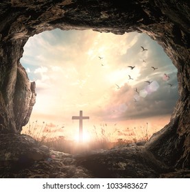 Easter Religious concept: Empty tomb stone with cross on meadow sunrise background - Powered by Shutterstock