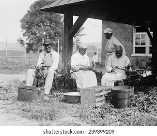 Elderly African Americans who were once slaves work together in a rural setting in 1920.
