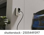 Electric Car Charging with EV charger at home, ev charger or wall box while working, 3d rendering