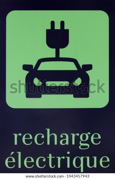 Electric car charging symbol in French language\
on a parking