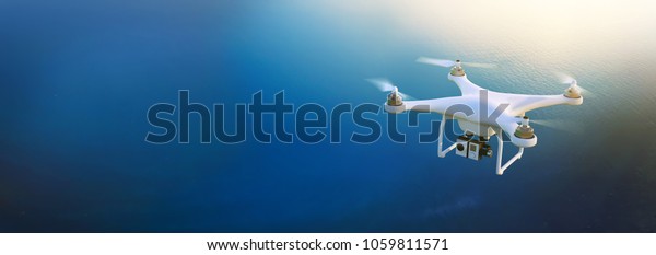 Electric drone flies in the\
sky. 3D illustration. Drone: 3d-model. Background:\
photo-panorama.