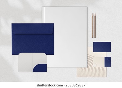 Elegant stationery set with blue and white envelopes, blank notebook, and business cards. Minimalist design with pencils. Elegant Office or business use of stationery set branding in blue and white. - Powered by Shutterstock