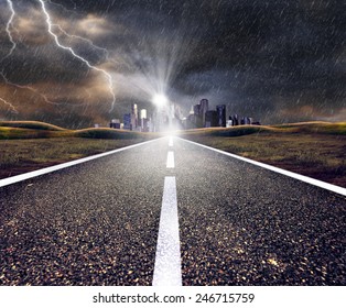 Empty Asphalt Road Towards A City In Storm