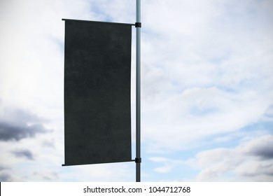 Empty Black Rectangular Flag Banner On Bright Sky Background. Advertisement And Commercial Concept. Mock Up, 3D Rendering 