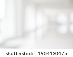 Empty blur white corridor hallway of modern white office building room with entrance door business blur background