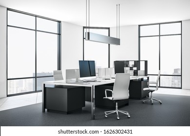 Empty computer in contemporary office interior with daylight. Creative designer desktop. 3D Rendering