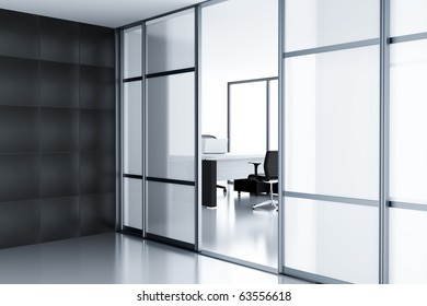 Empty Cubicle With Laptop On Table Behind A Glass Doors In Modern Office