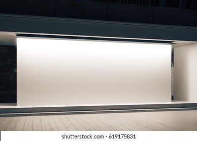 Empty Glass Shopfront With Blank White Banner At Night. Retail  Concept. Mock Up, 3D Rendering