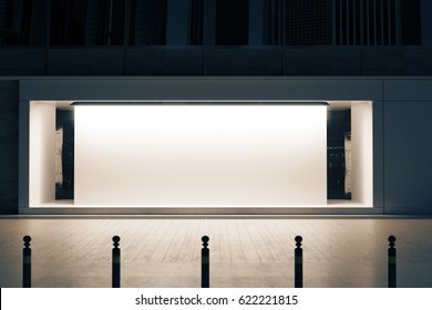 Empty Glass Shopfront With White Poster At Night. Retail  Concept. Mock Up, 3D Rendering