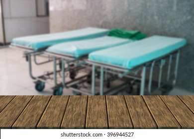 Empty Hospital Bed (blur Background With Wood Table Top For Display Or Montage Your Product)