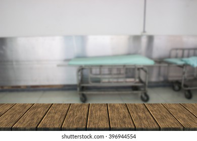 Empty Hospital Bed (blur Background With Wood Table Top For Display Or Montage Your Product)