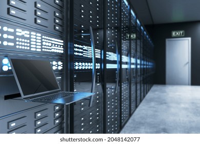 Empty laptop computer in illuminated server room interior. Internet, engineering and data concept. 3D Rendering