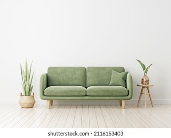 Empty living room wall mockup with green velvet sofa, pillow, snake plant in basket and leaves in wooden vase on blank white interior background. Illustration, 3d rendering