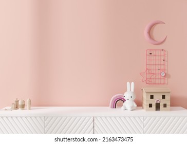 Empty Pink Wall. Mock Up Kids Room Interior In Contemporary Style. Close Up View. Free, Copy Space For Your Picture Or Other Small Object. Sideboard, Toys. 3D Rendering. Child Room Mock-up