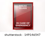 An empty red emergency box with an in case of emergency breakable glass on the front on an isolated background