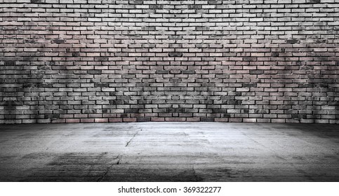Empty space, concrete floor with desaturated bricks