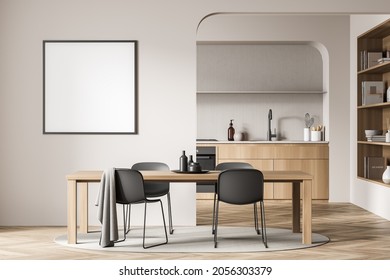 Empty Square Frame On The Beige Wall Of The Dining Room Interior With Black Chairs, Parquet Flooring And A Kitchen On The Background. A Concept Of Modern On Trend Design. 3d Rendering