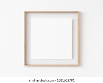 Empty Square Light Wood Picture Frame With White Center Hanging On White Wall. 3D Illustration.