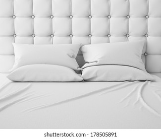 empty white bed and pillows with luxury headboard