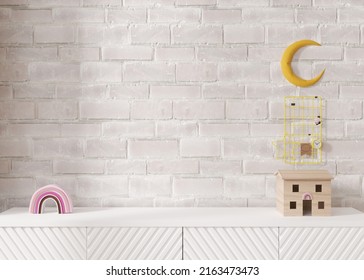 Empty White Brick Wall. Mock Up Kids Room Interior In Contemporary Style. Close Up View. Free, Copy Space For Your Picture Or Other Small Object. Sideboard, Toys. 3D Rendering. Child Room Mock-up