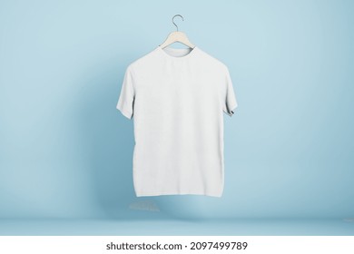 Empty White Tshirt Hanging On Blue Wall Background. Product Design And Presentation Concept. Mock Up Logo. 3D Rendering