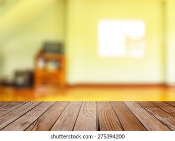 Empty wood table over blurred vintage wooden interior with bokeh background, product display template,deck,