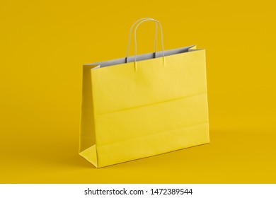 Empty yellow paper shopping bag with thin handles in modern studio. Advertising and branding. Side view. Mock Up. 3d rendering - Shutterstock ID 1472389544