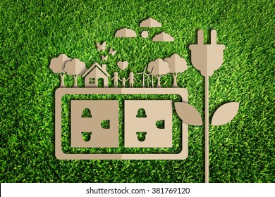  Energiesparkonzept. Papierschnitt des Ökos auf grünem Gras