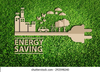 energy saving. Paper cut of Green city concept on green grass.