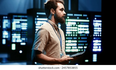 Engineer maintenancing server hub to optimize it for data processing requirements of artificial intelligence workloads. Specialist inspecting neural network data center used for machine learning - Powered by Shutterstock