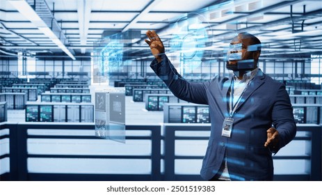 Engineer using augmented reality tech in data center, installing software, troubleshooting issues. African american expert in server hub looks at AR hologram, establishing performance benchmarks - Powered by Shutterstock