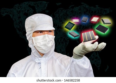 Engineer in working suit holding electronics components 
