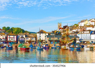 English harbour and seafront Brixham Devon England with boats anchored on a calm day with blue sky illustration like oil painting