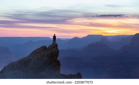 Epic Adventure Composite Of Man Hiker On Top Of A Rocky Mountain. Dramatic Sunset Sky. 3d Rendering Peak. Background Landscape From North America. Freedom Concept.