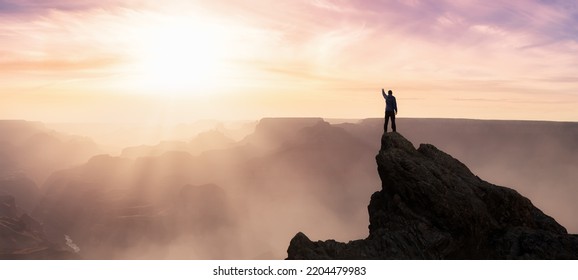 Epic Adventure Composite Of Man Hiker On Top Of A Rocky Mountain. Dramatic Sunset Sky. 3d Rendering Peak. Background Landscape From North America. Freedom Concept.