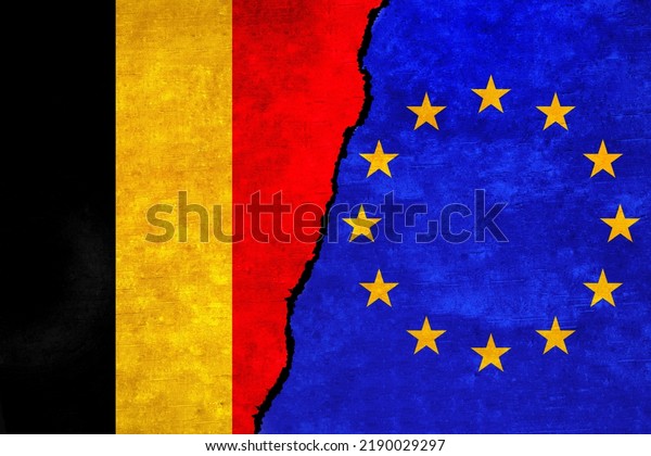 European Union and Belgium flags on a wall with a\
crack. Belgium and European Union flags together. EU Belgium\
alliance, politics, economy, trade, relationship and conflicts\
concept