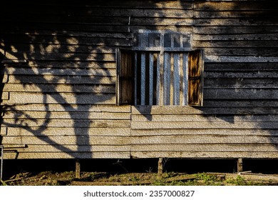 evening sun light made a shadow on old house wall